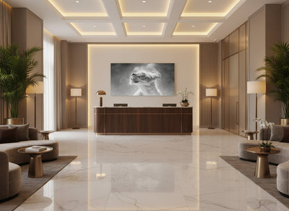 Modern lobby with reception desk, and a  large fine art print on the wall of an etheral lioness, 