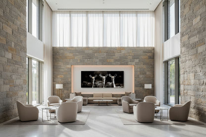 Oversized wall art featured in a contemporary reception lounge area with floor-to-ceiling windows and sculpted  elegant furniture.