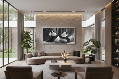 Large horizontal panda artwork displayed above curved designer sofa in contemporary lounge interior.