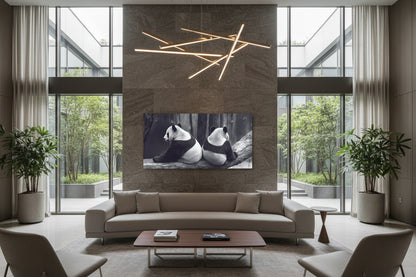 Large horizontal panda artwork displayed above low profile designer sofa in contemporary lounge interior.