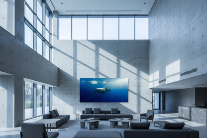 Oversized blue contemporary rhinoceros artwork displayed in a large concrete atrium with high ceilings and directional natural light.